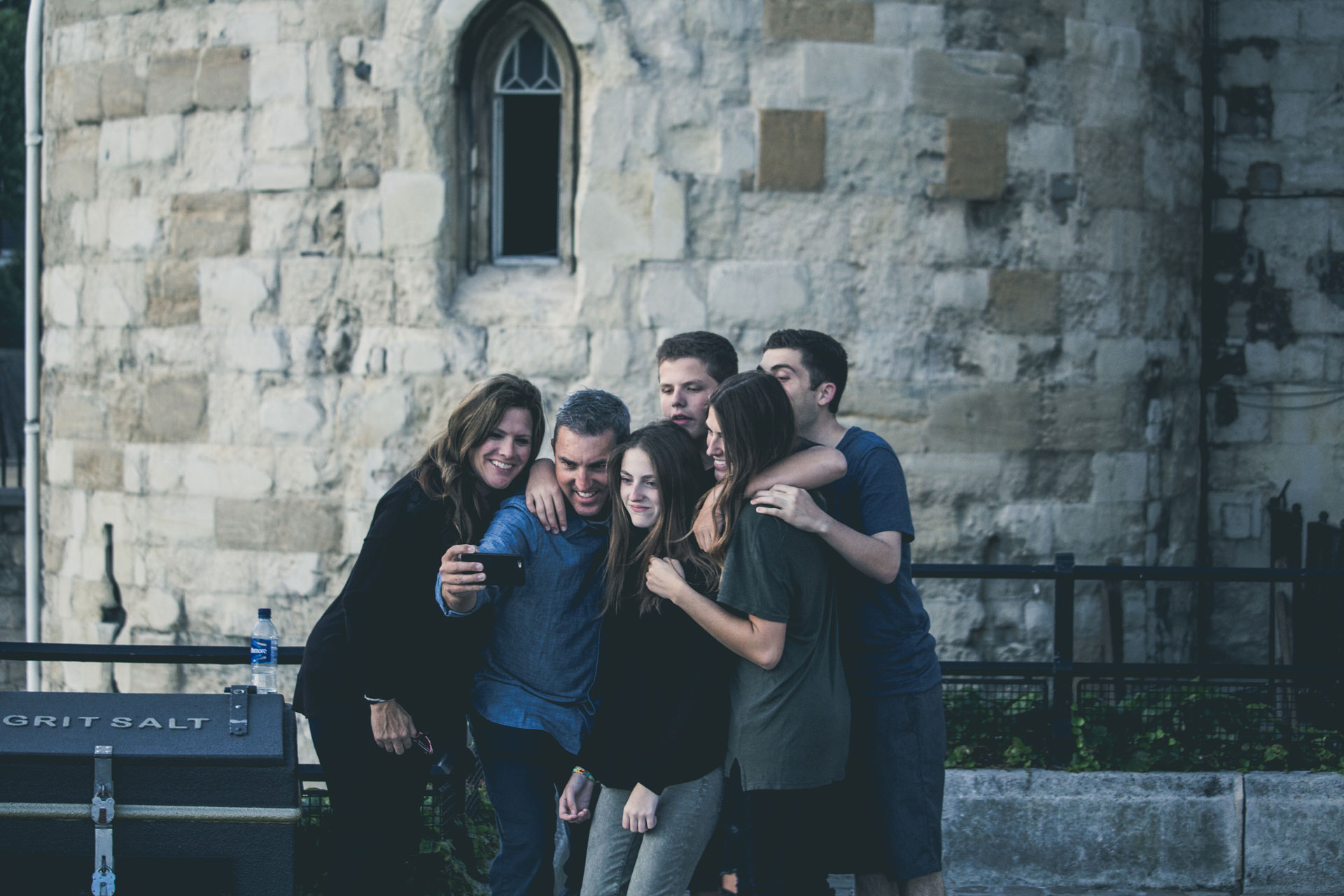 A group of friend huddles together to take a picture