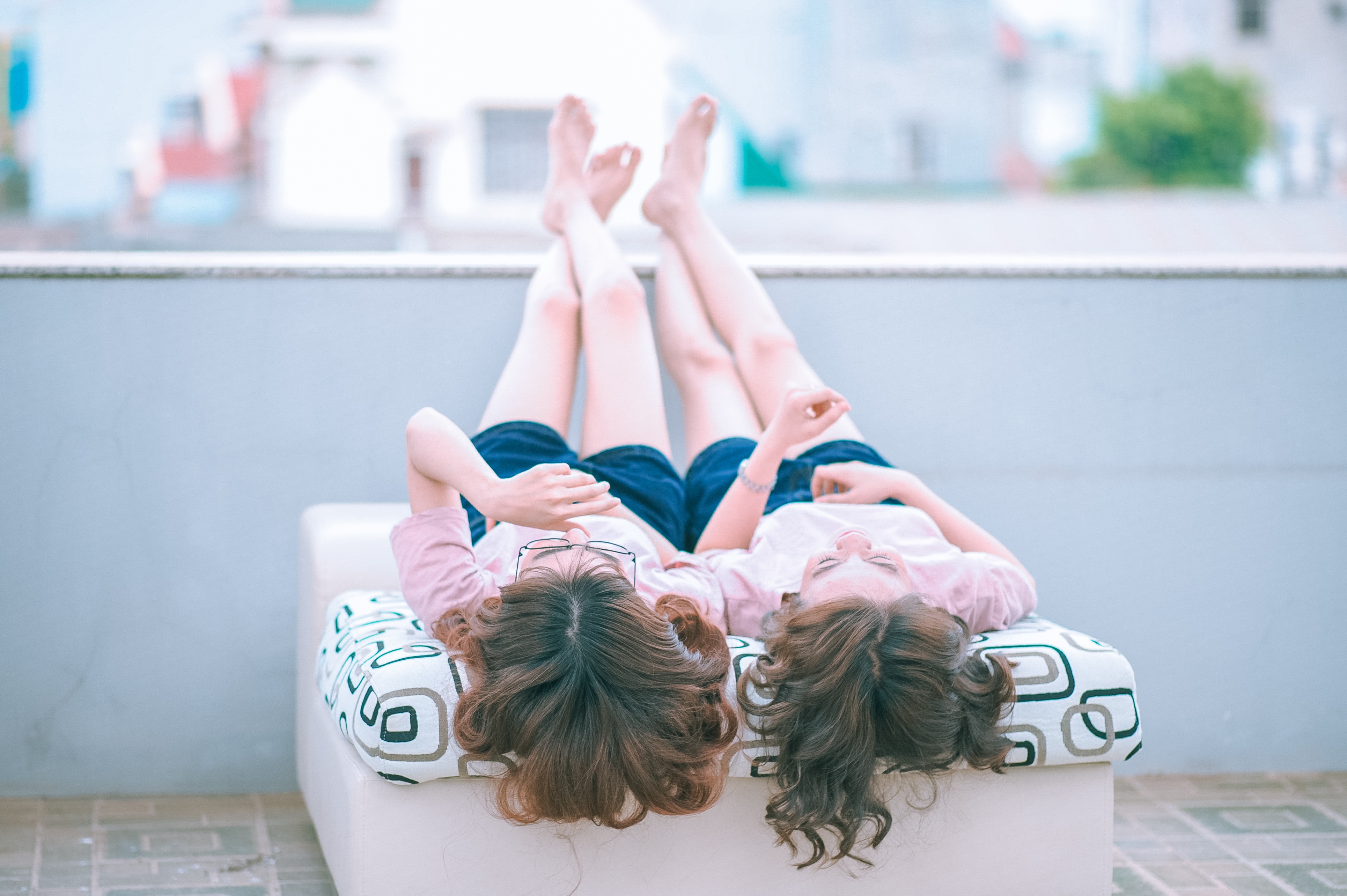 Two sisters lay close together