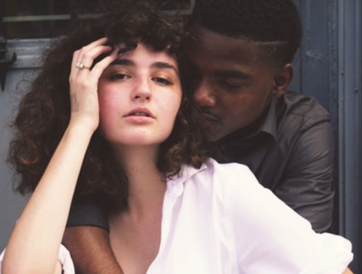 couple embracing on a set of stairs.