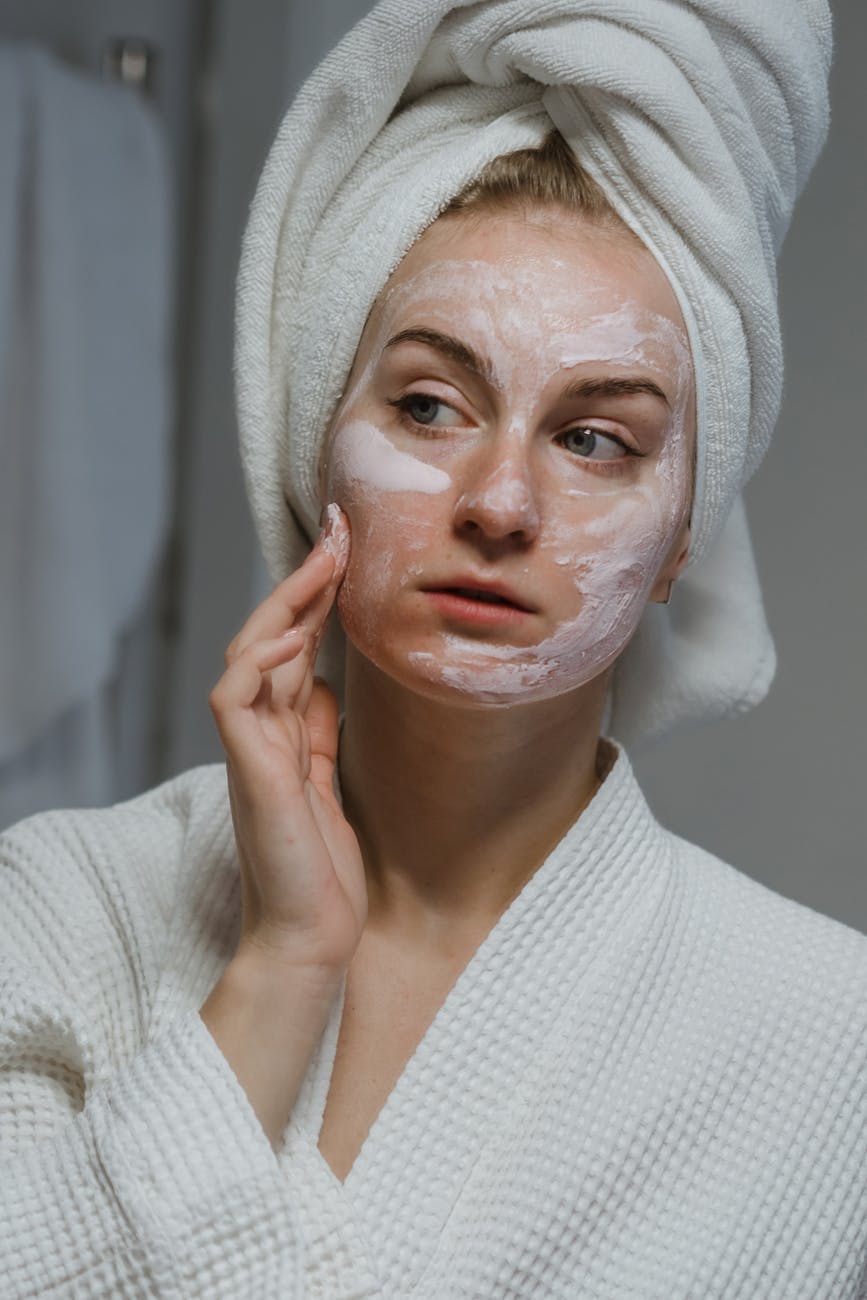 woman in white knit sweater with white face mask