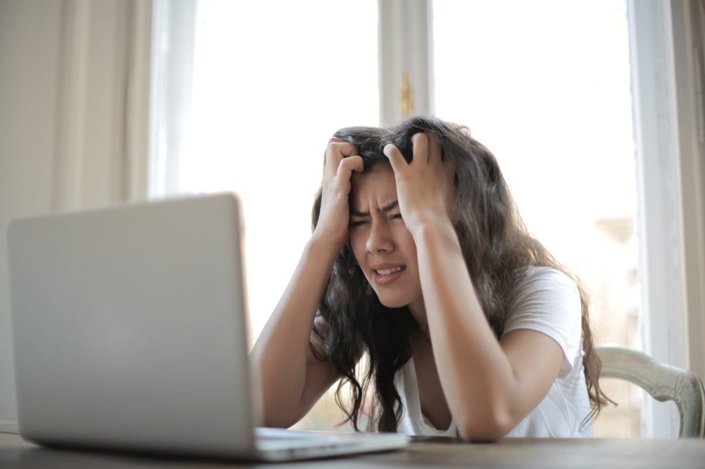 woman in white shirt showing frustration