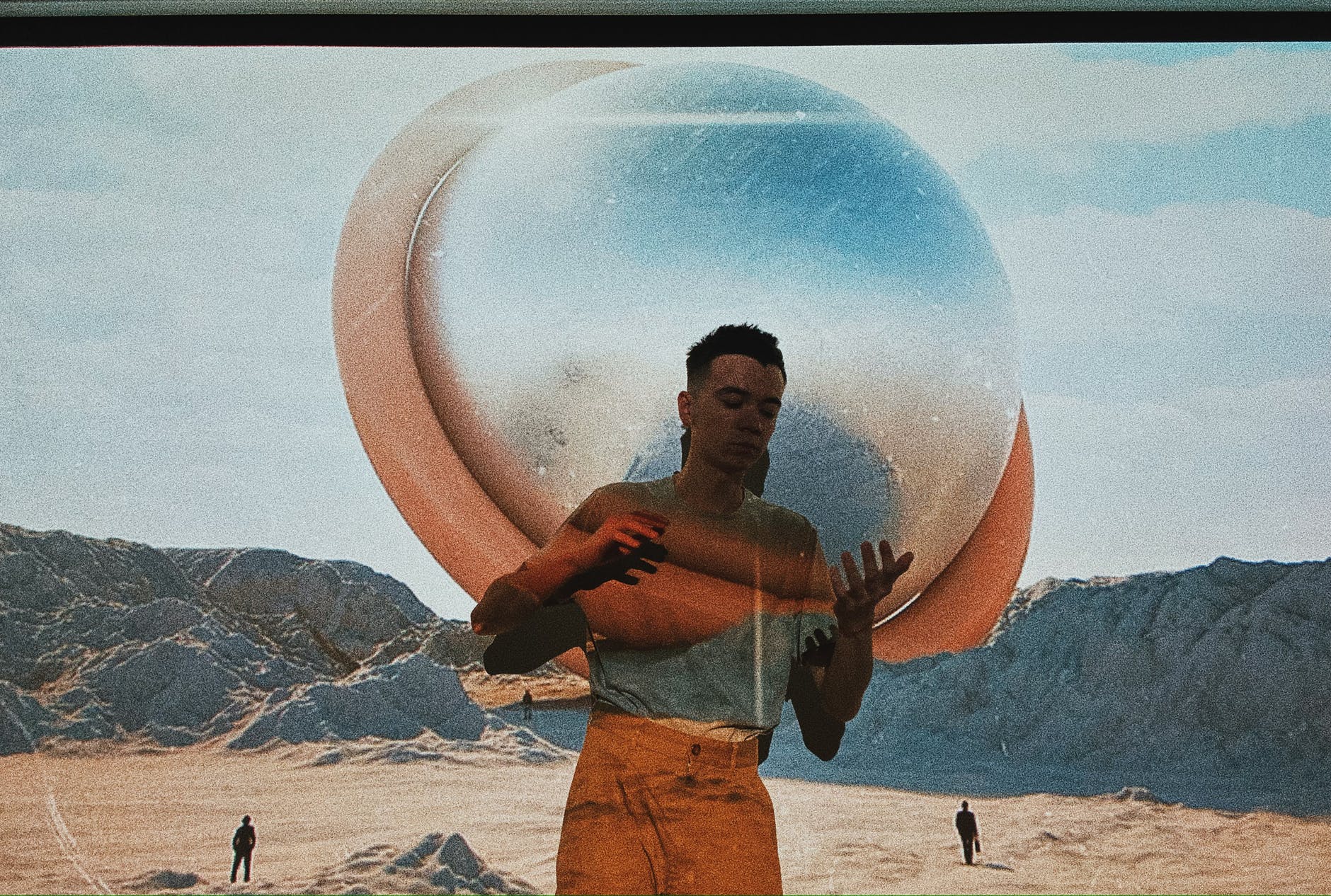 man covering screen with film