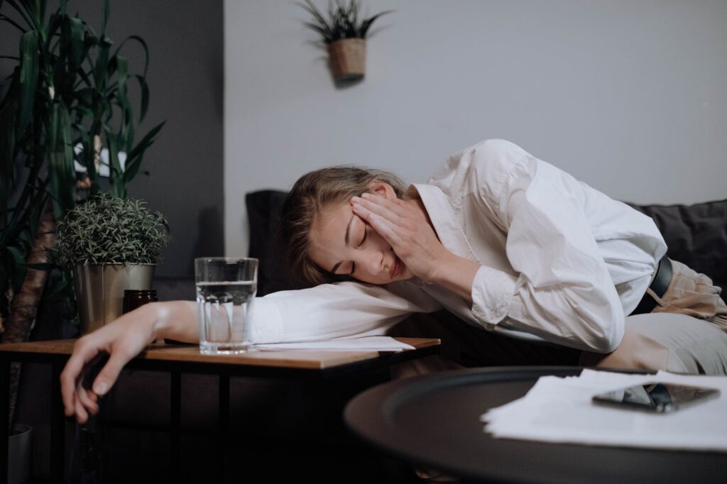 exhausted woman falling asleep on table