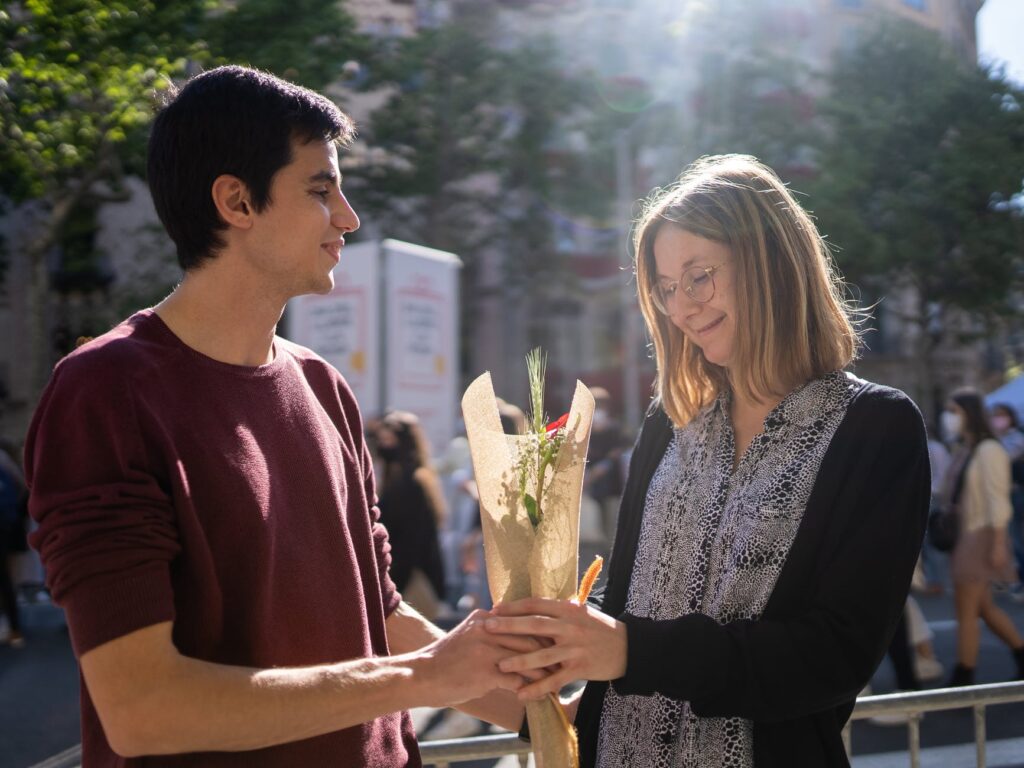 a man giving a red rose to his woman